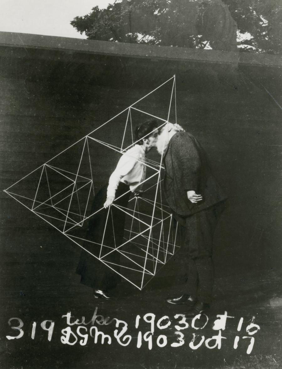 Alexander Graham Bell and Mabel kissing within a tetrahedral kite.